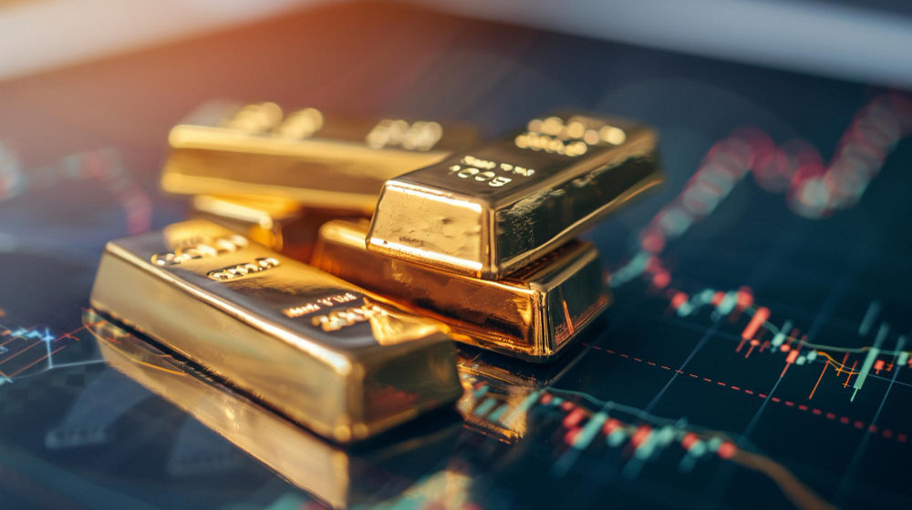 Gold bullion beside a professional XAU/USD trading chart, representing gold trading